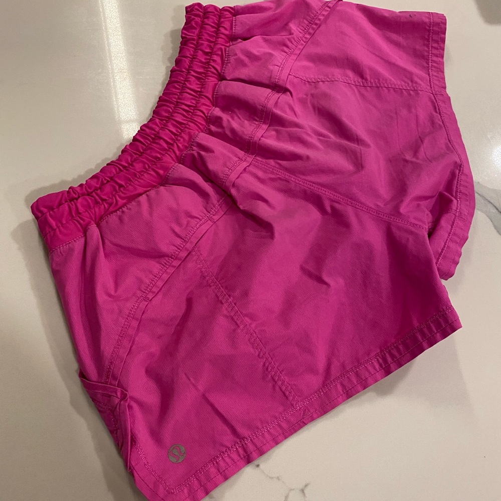 Lululemon hot pink shorts with pockets. Small stain as shown. Size 6
